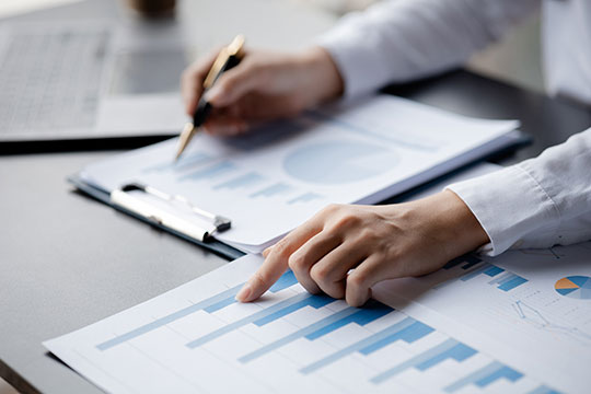 Businessman pointing at a bar chart on a company financial document